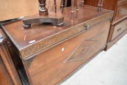 An early 20th Century oak ply bedding box, width approx. 115cm on castors