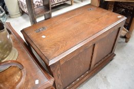 A 20th century oak blanket box, of traditional design with ornate iron hinges and double panelled