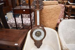 An early 20th century oak banjo barometer, with aneroid barometer dial, thermometer scale and