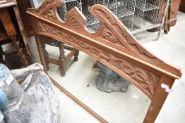 An Edwardian satinwood over-mantel mirror, with stipple carved decoration.