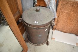 A traditional wrought iron and brass coal bucket