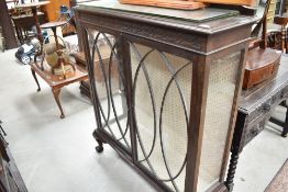 An Edwardian glass fronted book case having lined back