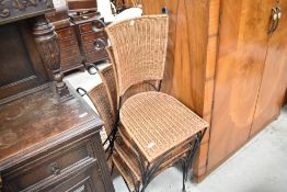 A set of four modern woven-wicker metal framed chairs