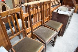 Three early 20th Century oak rail back dining chairs