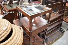 An Edwardian mahogany washstand of square section with three pierced apertures to top, over a single