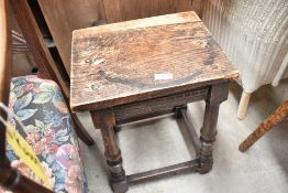 An 18th century style oak join stool, with moulded rails and turned supports, re-applied top with
