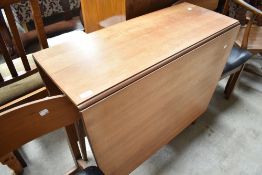A vintage drop leaf table and four chairs having vinyl seats