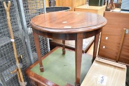 An Edwardian mahogany occasional coffee table on square tapered legs and spade feet
