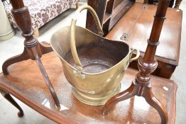 A brass helmet form coal scuttle, with hinged over handle