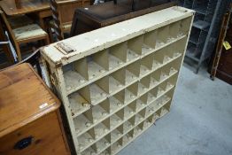 A vintage cream painted metal industrial shelving unit