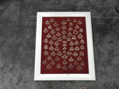 A framed display of Territorial Artillery Shoulder Titles including W.Lancashire, Clyde, London,