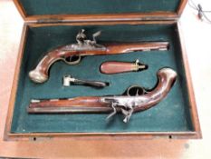 A cased set of two Flintlock Pistols by Bennett Royal Exchange London, proof marks on barrel, half