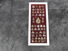 A framed display of Military Cap Badges plus one Helmet Plate including Royal Scots, East