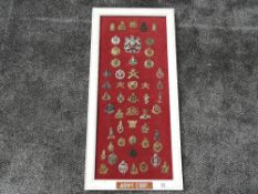A framed display of Military Cap Badges for the Army Corps including Royal Army Ordnance Corps,