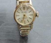 A lady's 9ct gold wrist watch by Sekonda having baton numeral dial to champagne face on gold