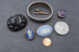 A small selection of jewellery including mourning brooch, Wedgwood brooches, HM silver hinged