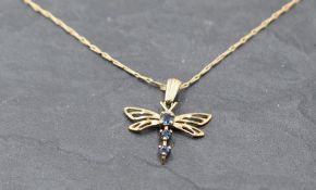 A 9ct gold dragonfly pendant having sapphire decoration on a 9ct gold fine link chain, approx