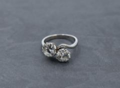 A diamond dress ring having a duo of diamonds, each approx 1.5ct in a claw set crossover mount on