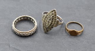 A small yellow metal signet ring stamped 9ct, a yellow metal full eternity ring having paste stones,