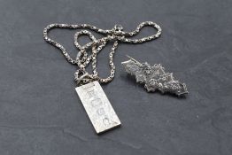 A silver ingot pendant having oversized Silver Jubilee (1977) hallmarks and engraved decoration on a