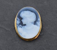 A blue agate cameo brooch/pendant depicting a maiden in profile in a 9ct gold collared mount, approx