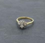 A lady's dress ring having a diamond cluster with central oval diamond surrounded by baguette and