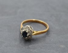 A sapphire and diamond chip cluster ring having an illusionary mount on an 18ct gold loop, size Q/
