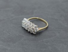 A cubic zirconia dress ring having three rows of stones in a claw set panel on a 9ct gold loop, size