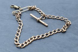A 9ct rose gold watch chain with T bar, missing clasps, approx 17g, with a rolled gold brooch clip