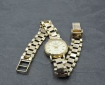 A 9ct gold wrist watch by Rotary having a baton numeral dial to champagne face in gold case with