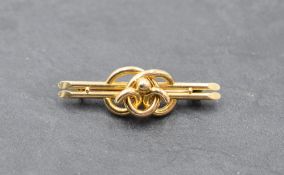 A yellow metal bar brooch stamped 15ct having knot detail, approx 3.9g