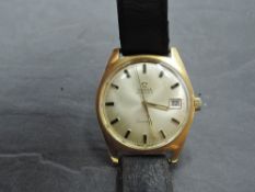 A gent's gold plated Omega Geneve automatic wrist watch having baton numeral dial with date aperture