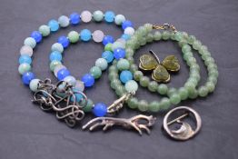 Four HM silver brooches including Scottish & Irish and two strings of beads including jadeite style
