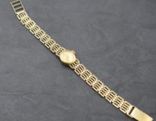 A lady's 9ct gold wrist watch by Rotary having baton numeral dial to champagne coloured oval face in