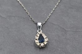 A cubic zirconia and blue paste teardrop cluster in white metal mount stamped 925 on a white metal