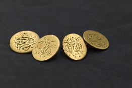 A pair of 18ct gold cufflinks having monogrammed oval discs with figure of eight connectors,