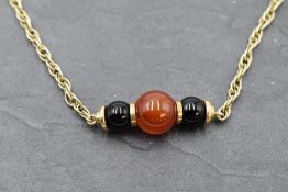 A 9ct gold rope chain necklace with central three bead panel, approx 15' & 13.2g