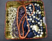 A small selection of bead necklaces including rough cut amethyst, coral and pearl