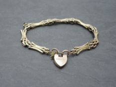 A yellow metal decorative gate bracelet stamped 9C having padlock clasp, approx 5.6g