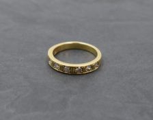 A diamond half eternity ring having seven pave set diamonds, total approx 0.450ct on a yellow