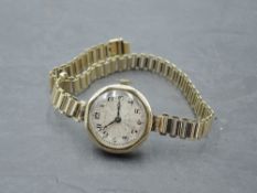 A lady's vintage 9ct gold Rolex wrist watch having Arabic numeral dial to engine turned face in gold