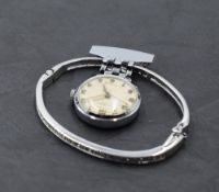 A Swarovski crystal set hinged bangle and a vintage nurse's watch