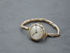 A vintage 9ct rose gold wrist watch by Sir John Bennett having Arabic numeral dial to engine