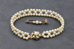A seed pearl woven bracelet having pearl and diamond chip set clasp and a 9ct gold bar brooch having