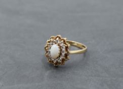 An opal and crystal open cluster having wire and ball twist decoration on a 9ct gold loop, size