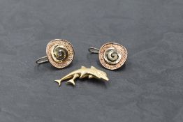 A pair of yellow metal Artisan style spiral disc loop earrings bearing worn marks, test as gold, and