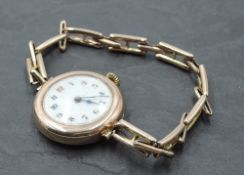 A lady's vintage 9ct rose gold wrist watch having Arabic numeral dial to white face with yellow