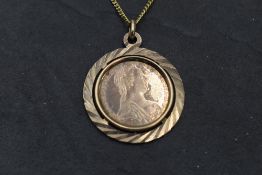 An Austrian Maria Theresa Thaler style coin in a yellow metal removable pendant mount stamped 333 on