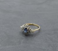 A powder blue sapphire and diamond lozenge shaped cluster in a claw set basket mount on a 9ct gold