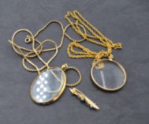 A glass locket with yellow metal surround stamped 9ct on a yellow metal chain, another similar and a